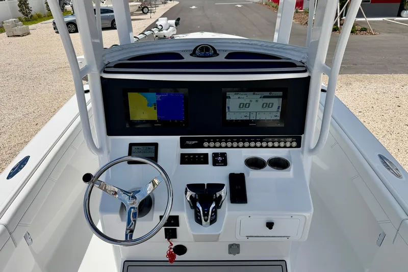 Slide: The Image of Center console of 2025 Bluewater 25t boat with navigation screens and controls. - 13