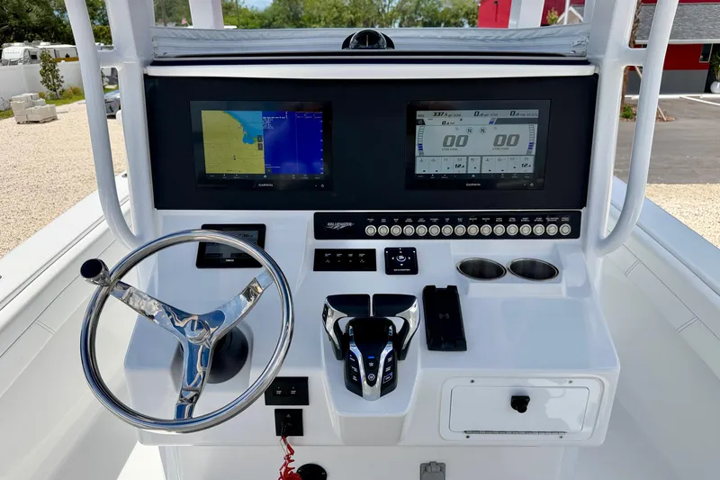 Slide: The Image of 2025 Bluewater 25t boat console with steering wheel, dual displays, and control panel. - 14