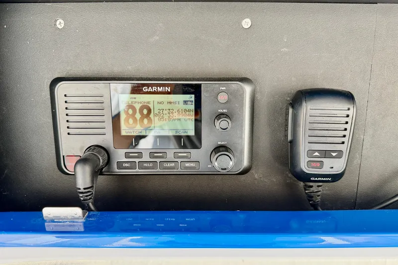 Slide: The Image of Garmin marine radio system on Bluewater 25t, 2025 model, with microphone and display. - 23