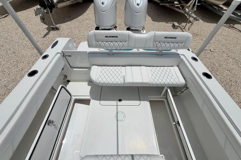 Slide: The Image of 2025 Bluewater 25t boat interior with white seating and storage compartments. - 26