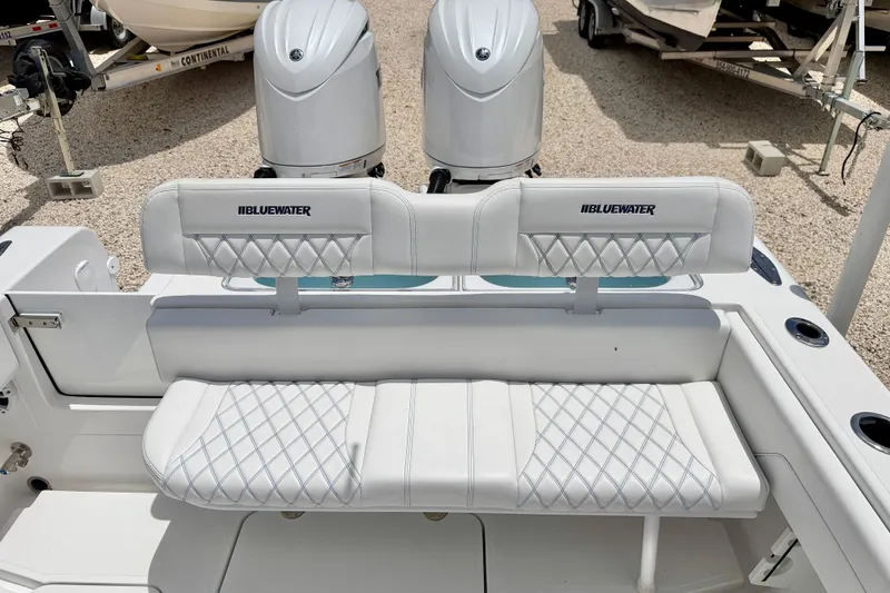 Slide: The Image of 2025 Bluewater 25t boat interior with dual engines and cushioned seating. - 27