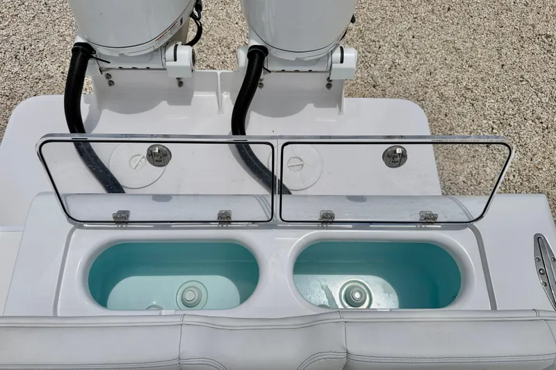 Slide: The Image of Bluewater 25t 2025 model boat with dual live wells and outboard motors. - 30
