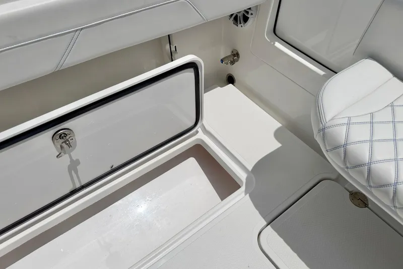 Slide: The Image of Interior view of 2025 Bluewater 25t boat, featuring storage compartment and cushioned seating. - 31