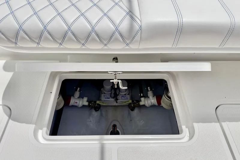 Slide: The Image of Compartment of 2025 Bluewater 25t boat with cushioned seating and storage access. - 32