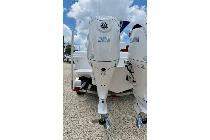 Slide: The Image of Twin Yamaha outboard engines on a 2025 Bluewater 25t boat under a cloudy sky. - 38