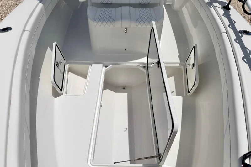 Slide: The Image of 2025 Bluewater 25t boat interior with open storage compartments and cushioned seating. - 41
