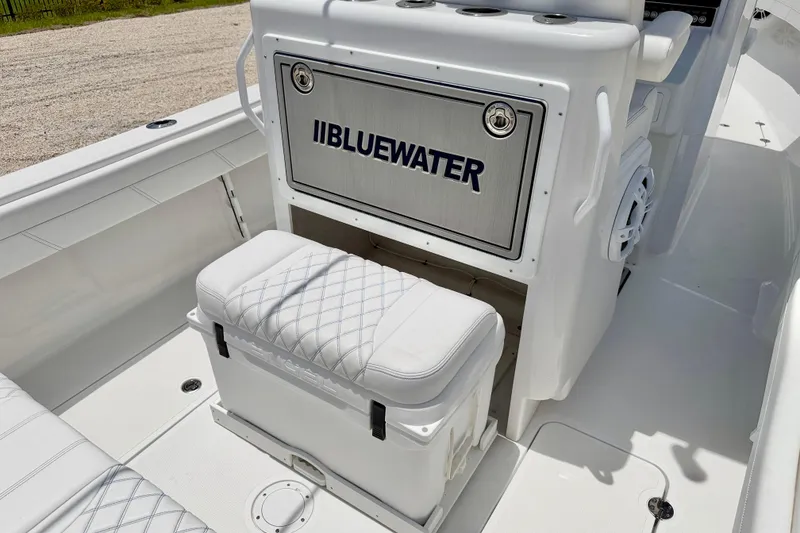 Slide: The Image of 2025 Bluewater 25t boat interior with cushioned seating and storage compartment. - 44