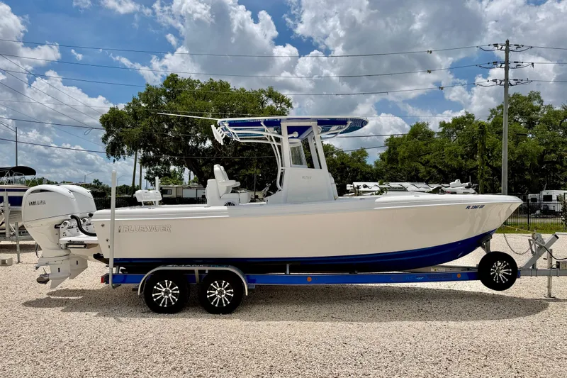 Slide: The Image of 2025 Bluewater 25t boat on trailer, featuring Yamaha outboard motor. - 7