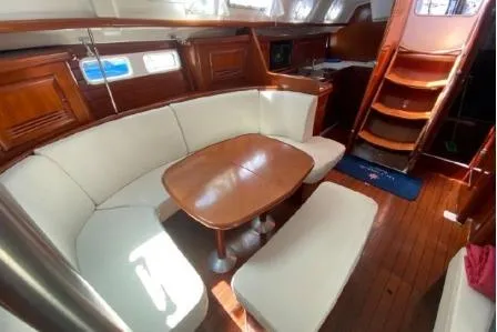 Slide: The Image of Interior of 2003 Beneteau 423 sailboat with elegant wood finish and cozy seating area. - 14