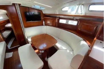 Slide: The Image of Interior of 2003 Beneteau 423 yacht with elegant wood finish and cozy seating area. - 15