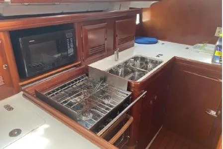 Slide: The Image of 2003 Beneteau 423 yacht kitchen with stove, sink, and microwave. - 18