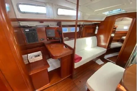 Slide: The Image of 2003 Beneteau 423 yacht interior with wooden finish and white seating. - 21