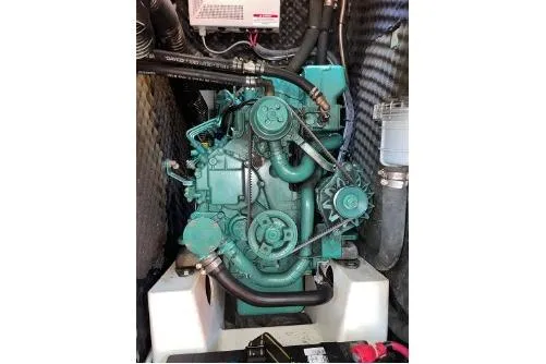 Slide: The Image of Engine of a 2003 Beneteau 423 sailboat, showcasing intricate mechanical components. - 23