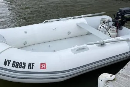 Slide: The Image of Inflatable boat docked on water, featuring registration number NY 6895 HF. - 25