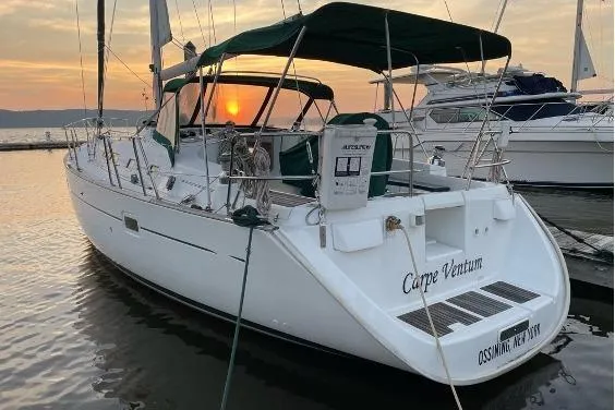 Slide: The Image of Beneteau 423 sailboat, 2003 model, docked at sunset with green canopy. - 3
