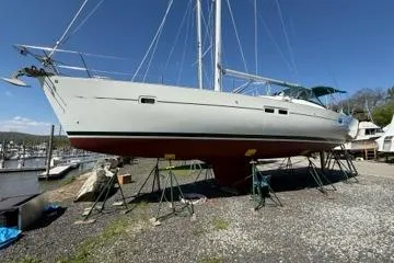 Slide: The Image of 2003 Beneteau 423 sailboat on stands, displayed outdoors at a marina. - 5
