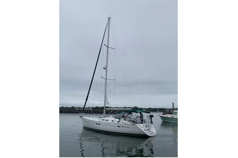 Slide: The Image of 2003 Beneteau 423 sailboat on calm water under overcast sky. - 6