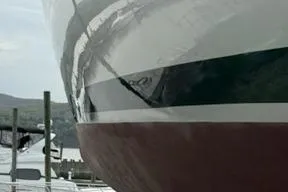 Slide: The Image of Close-up of a 2003 Beneteau 423 yacht hull at a marina. - 9