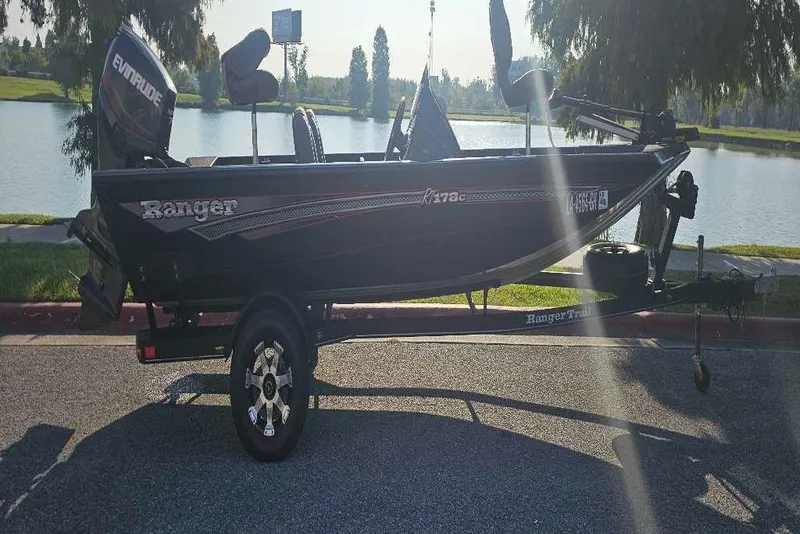 Slide: The Image of 2018 Ranger RT178C fishing boat on trailer by a lake. - 1