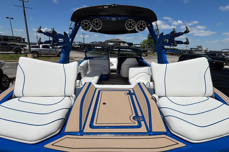 Slide: The Image of 2026 MB B52 23 Alpha boat interior with white and blue seating, outdoor setting. - 10