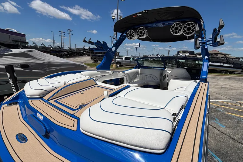 Slide: The Image of 2026 MB B52 23 Alpha boat with sleek design, blue accents, and spacious seating. - 14