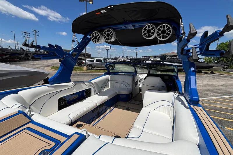 Slide: The Image of 2026 MB B52 23 Alpha boat interior with white seating and blue accents. - 15