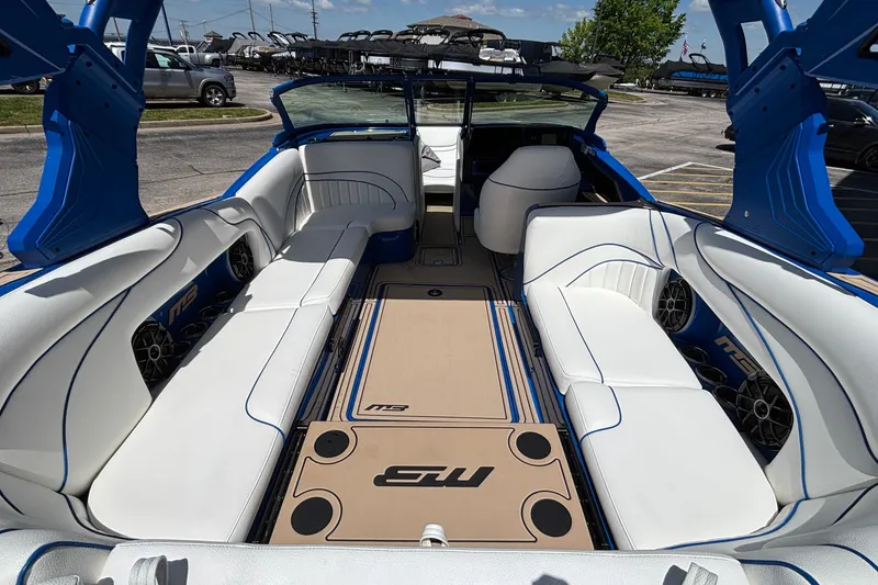 Slide: The Image of Interior of 2026 MB B52 23 Alpha boat with white seating and blue accents. - 16