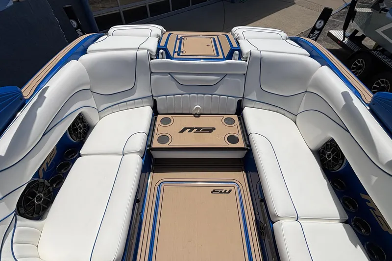 Slide: The Image of Luxurious interior of 2026 MB B52 23 Alpha boat with white seating and blue accents. - 17