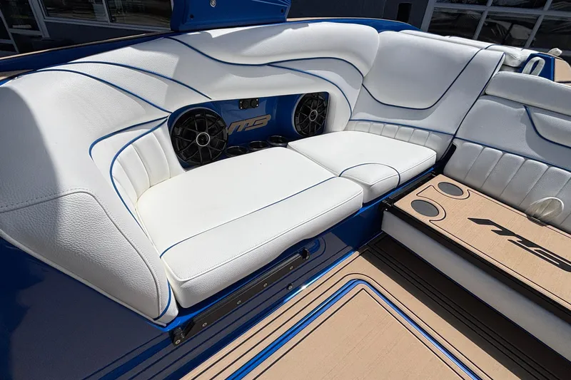Slide: The Image of Luxurious seating in 2026 MB B52 23 Alpha boat with white upholstery and speakers. - 18