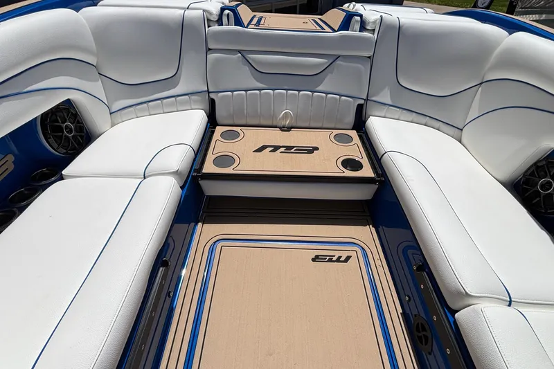 Slide: The Image of Luxurious interior of 2026 MB B52 23 Alpha boat with white seating and blue accents. - 19