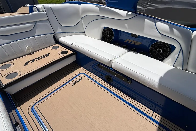 Slide: The Image of Interior of 2026 MB B52 23 Alpha boat with white seating and integrated speakers. - 20