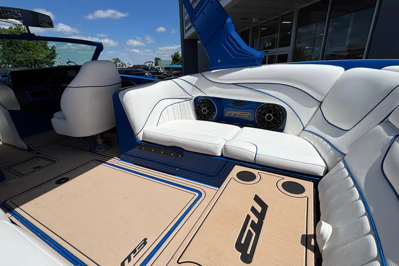 Slide: The Image of Luxurious interior of 2026 MB B52 23 Alpha boat with white seating and blue accents. - 22