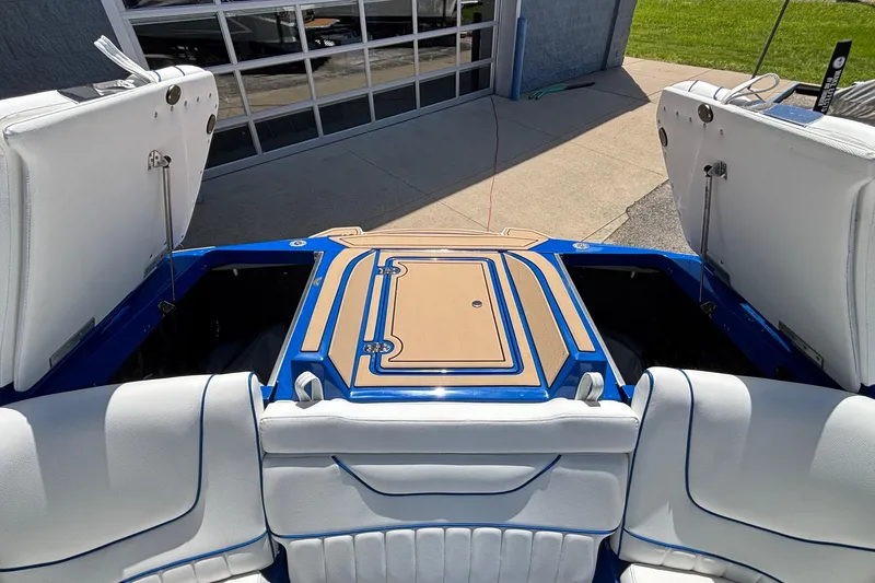 Slide: The Image of 2026 MB B52 23 Alpha boat interior with open storage compartments and cushioned seating. - 25