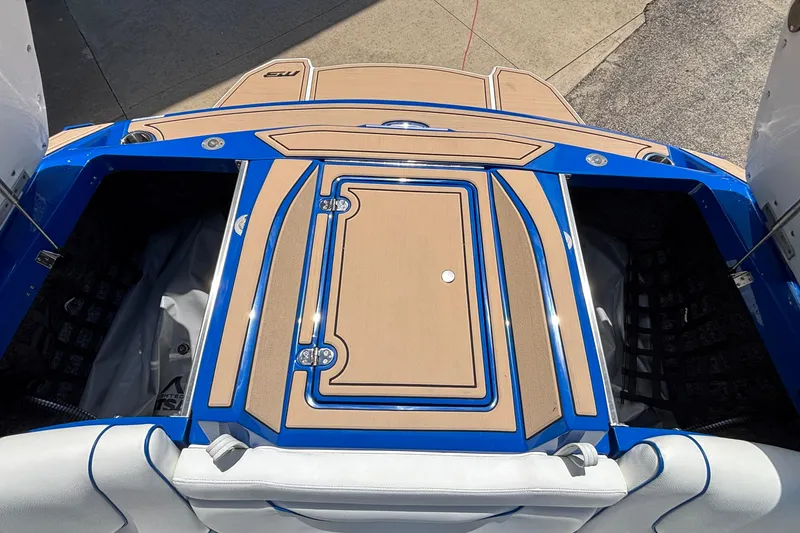 Slide: The Image of 2026 MB B52 23 Alpha boat deck with blue accents and storage compartments. - 26