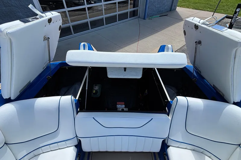 Slide: The Image of Interior view of 2026 MB B52 23 Alpha boat with open storage compartments. - 27