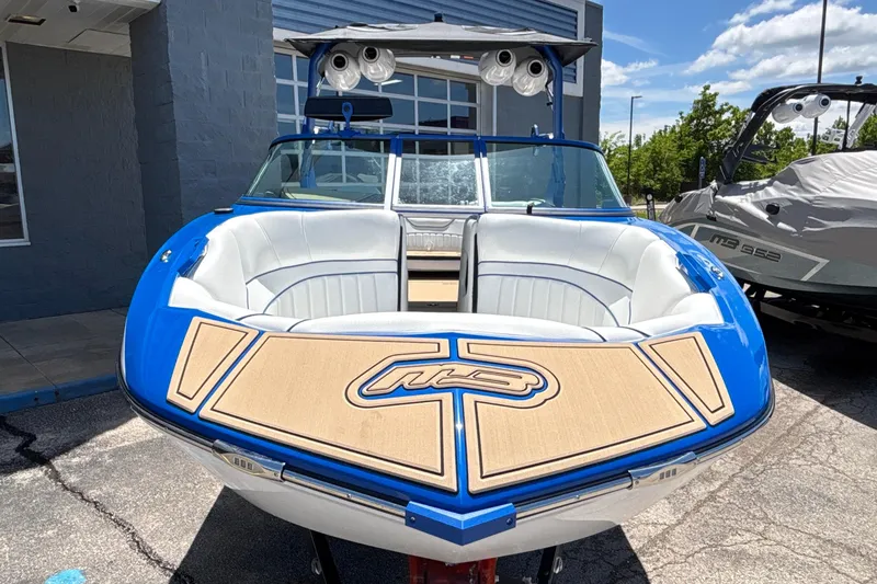 Slide: The Image of 2026 MB B52 23 Alpha boat with blue and white design, parked outdoors. - 3