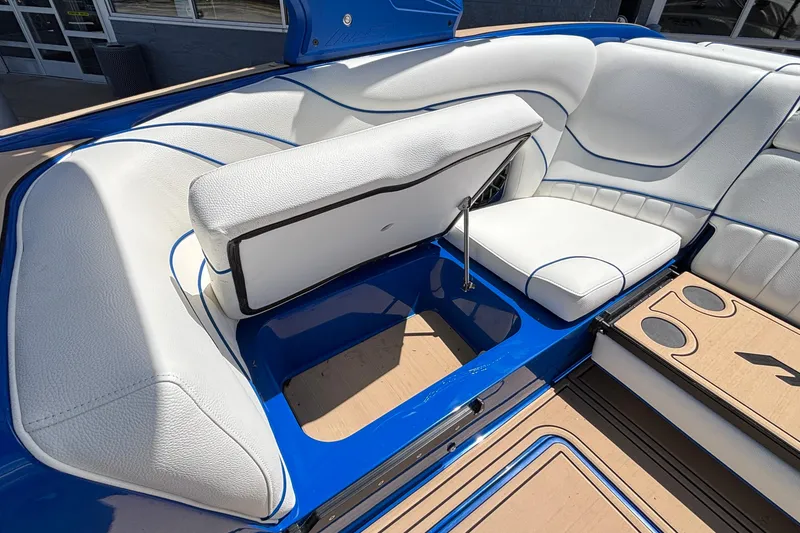 Slide: The Image of 2026 MB B52 23 Alpha boat interior with white and blue seating and storage compartment. - 32