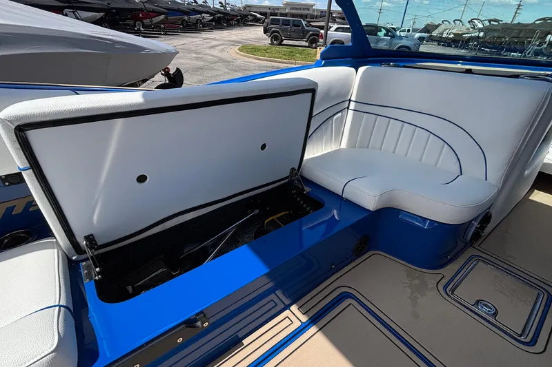 Slide: The Image of 2026 MB B52 23 Alpha boat interior with open storage compartment and white seating. - 34