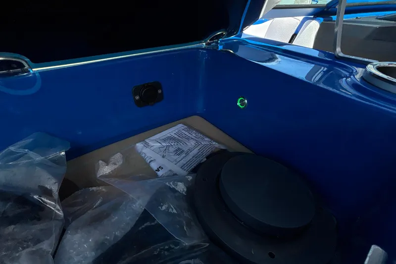 Slide: The Image of Interior of 2026 MB B52 23 Alpha boat, featuring blue storage compartment. - 38