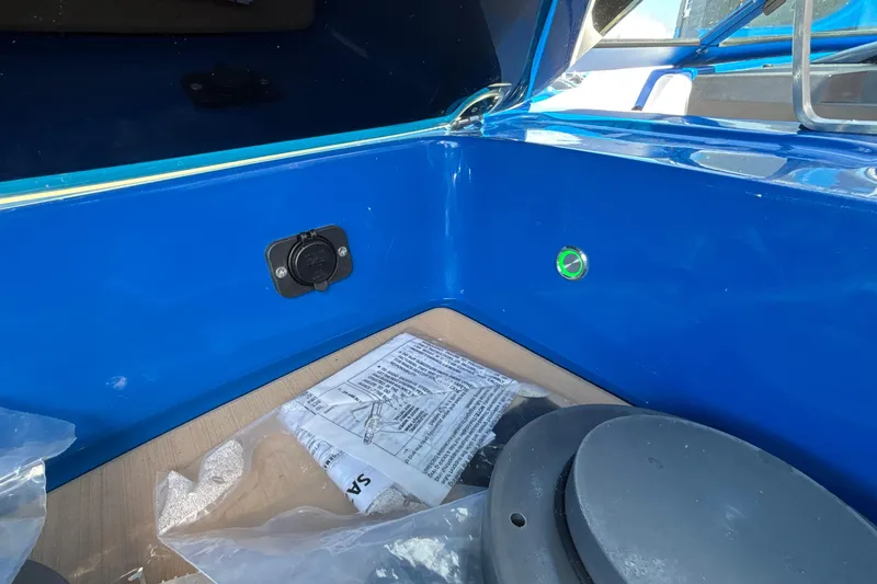 Slide: The Image of Blue interior of 2026 MB B52 23 Alpha boat with plug socket and documents. - 39