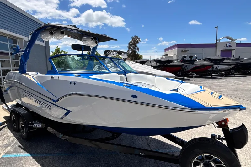 Slide: The Image of 2026 MB B52 23 Alpha boat with sleek design, blue and white color scheme, on trailer. - 4