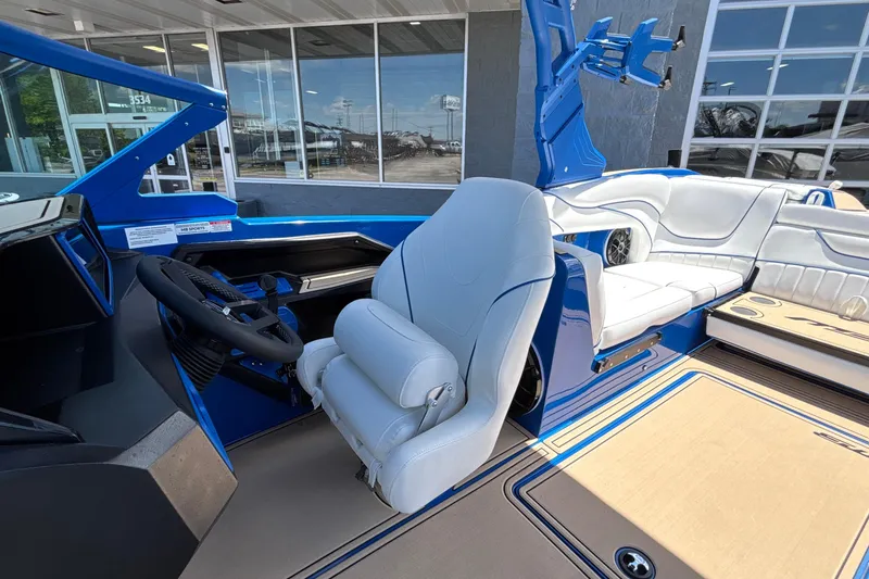 Slide: The Image of 2026 MB B52 23 Alpha boat interior with blue and white seating and modern steering. - 46