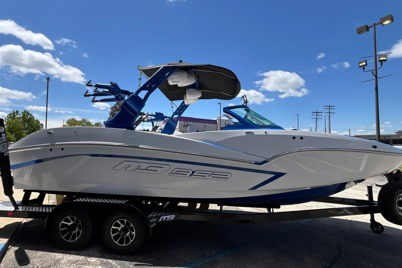 Slide: The Image of 2026 MB B52 23 Alpha boat on trailer under blue sky. - 5