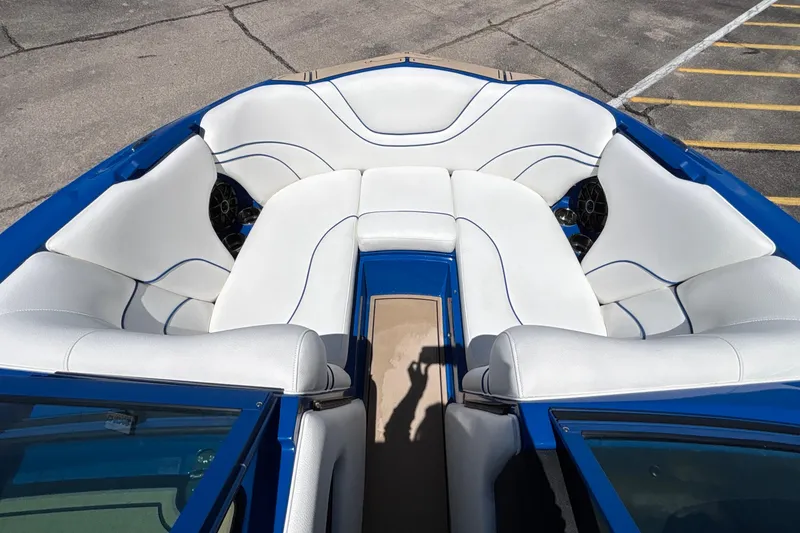Slide: The Image of Luxurious interior of 2026 MB B52 23 Alpha boat with white seating and blue accents. - 52