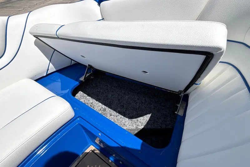 Slide: The Image of Open storage compartment in 2026 MB B52 23 Alpha boat with white and blue seating. - 55