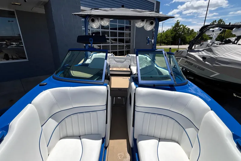 Slide: The Image of 2026 MB B52 23 Alpha boat with white and blue interior, docked outdoors. - 57