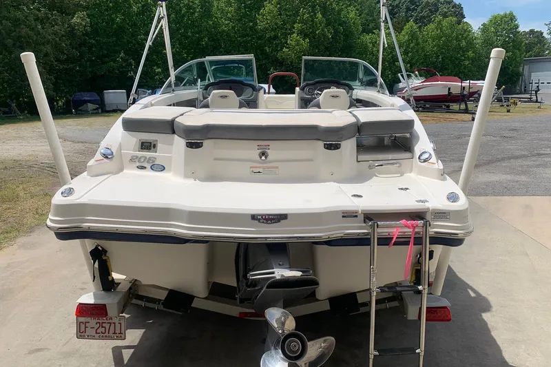 Slide: The Image of 2014 Chaparral 206 SSi boat, rear view, parked outdoors with trees in background. - 3