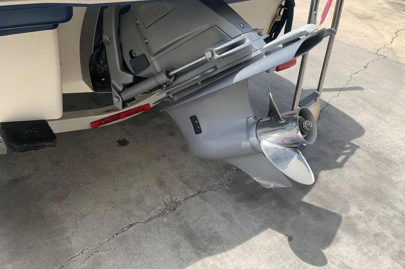 Slide: The Image of 2014 Chaparral 206 SSi boat propeller and outdrive on concrete surface. - 4