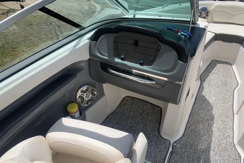 Slide: The Image of Interior of a 2014 Chaparral 206 SSi boat with seating and dashboard details. - 7