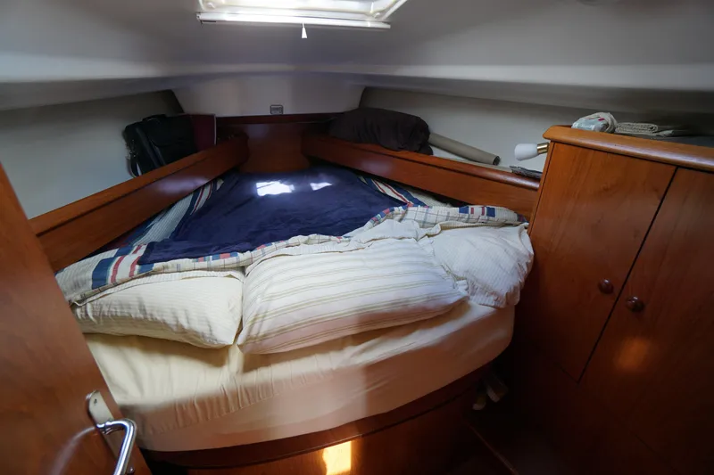 Slide: The Image of Cozy cabin interior of 2004 Jeanneau Sun Odyssey 37 sailboat with wooden furnishings. - 14